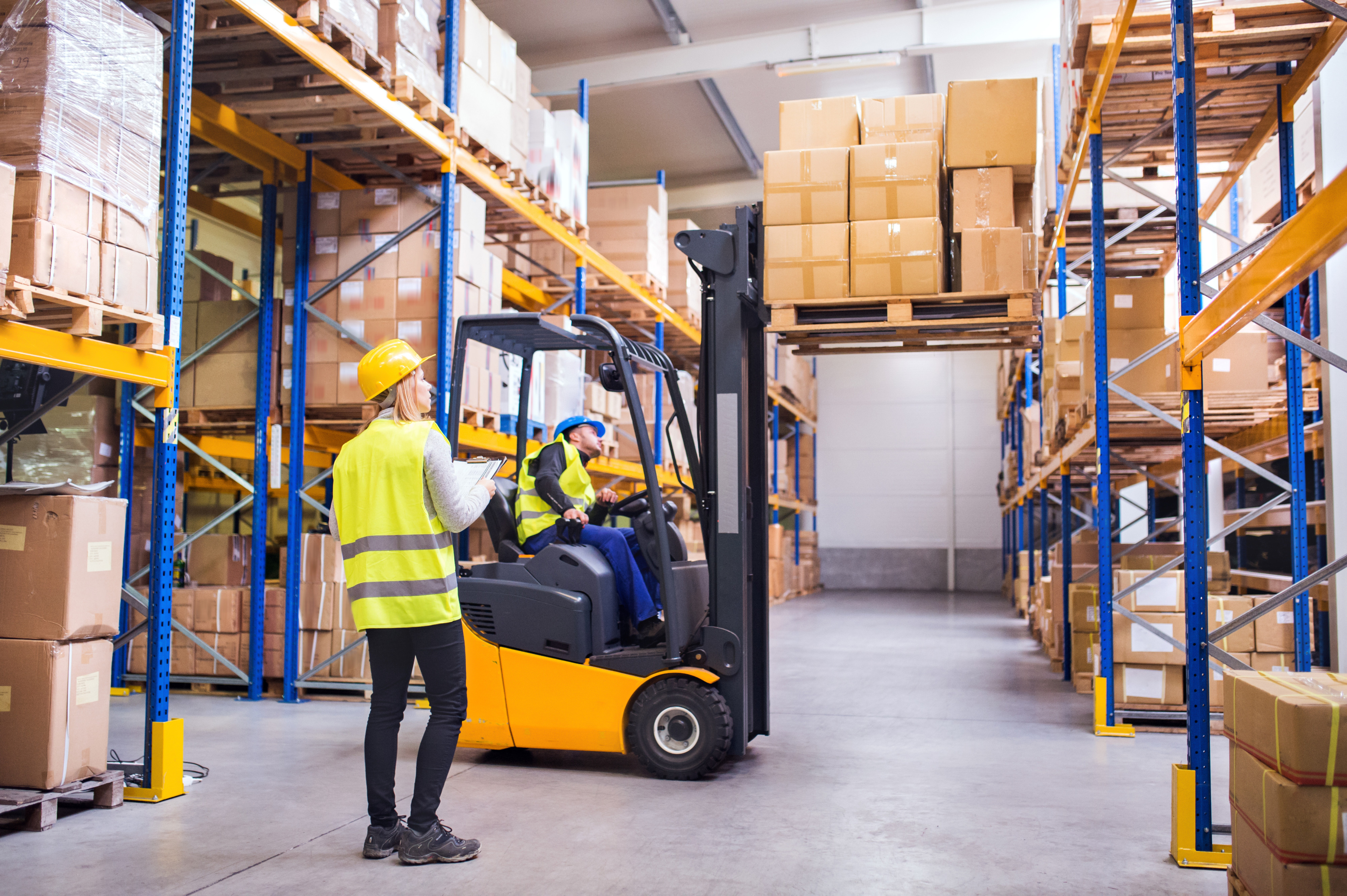 Logistical workers with reachtruck