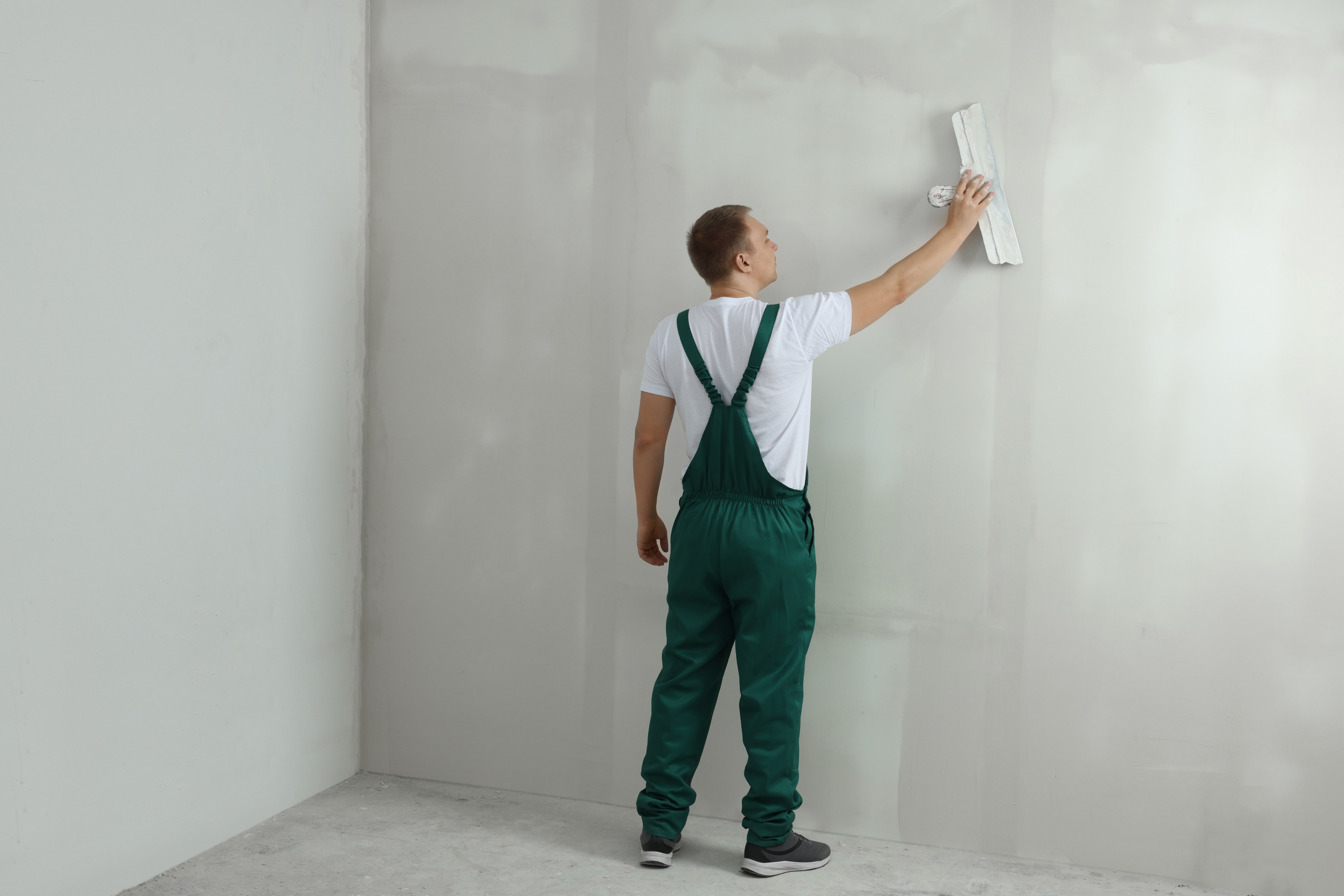 Worker plastering a wall